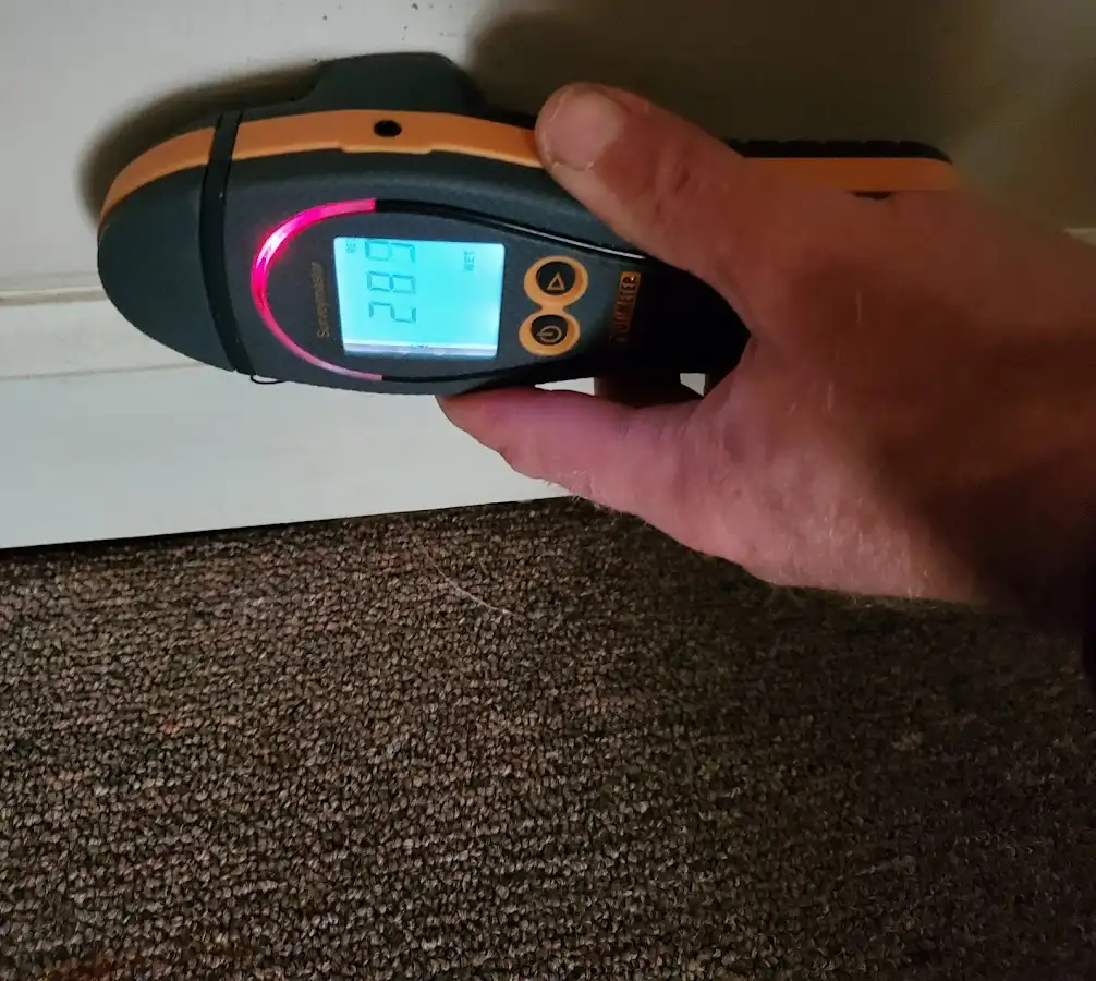 Moisture detection at baseboard during Storm Damage Restoration in Marietta